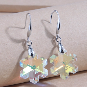 Macro shot of snowflake crystal drop earrings with aurora iridescent finish on hooks