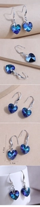 Detail view of heart-shaped crystal earrings showing 4.8cm length and gradient blue color