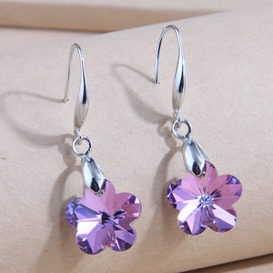 Detailed close-up of purple plum blossom crystal earrings with silver-tone hooks
