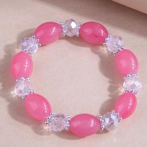 Detail of pink resin beads and clear faceted crystals with silver floral spacers on a bracelet