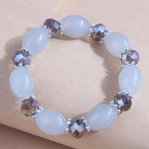 Detail of beaded bracelet with light blue oval stones and brown faceted crystals