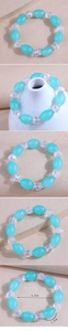 Detail view of light blue resin beads and crystal bracelet with 5.5cm inner diameter