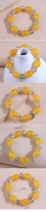Detail view of yellow resin beads bracelet with 5.5cm inner diameter measurement