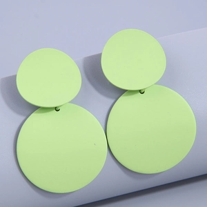 Detail view of neon green matte double disk earrings with minimalist circular design