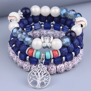 Detail of bohemian multilayer beads with tree of life charm and blue lava stone texture