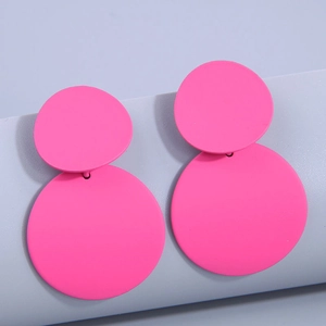 Neon pink matte geometric dangle earrings with dual circular design on blue background