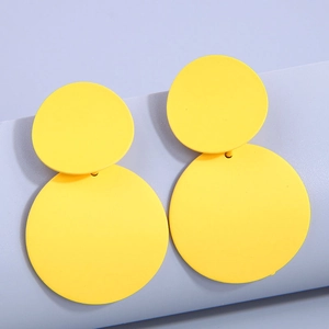 Minimalist double disc drop earrings in bright yellow matte finish on purple stand