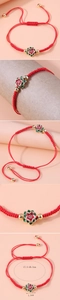 Detail of red string bracelet with enamel lotus flower pendant and size dimensions