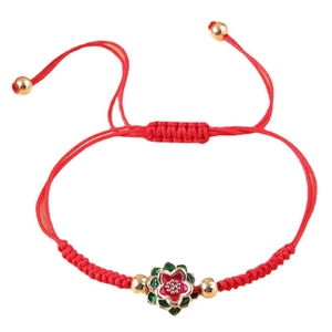 Handmade red braided rope bracelet with enamel flower charm and golden bead accents