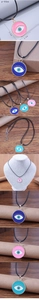 Detail view of colorful Evil Eye pendants with size specs and wax cord necklace chain