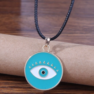 Minimalist green evil eye pendant necklace with gold lashes and black cord strap
