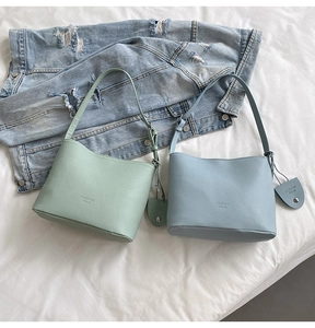 Detailed texture of mint green and sky blue pebbled leather bucket bags for women