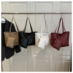 Detail view of woven leather tote set with matching zipper pouches in four colors