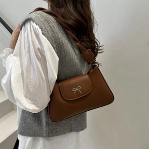 Brown leather underarm bag with silver bow buckle and twisted rope shoulder strap