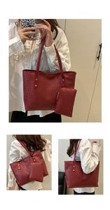 Detailed view of red woven texture on a large tote bag with matching pouch and rivets