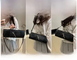 Black crocodile pattern cylinder bag shown in three styles: handbag, shoulder, and crossbody