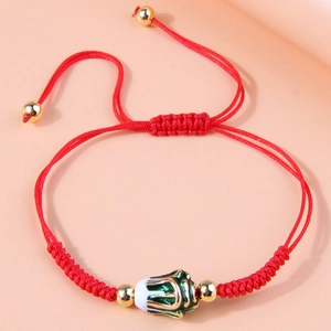 Handmade woven red string bracelet with floral enamel bead and gold-plated accents