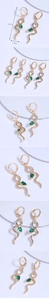 Detailed view of 4.5cm long gold-plated snake earrings with green teardrop stones