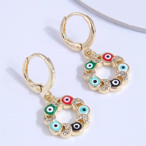 Golden hoop earrings with colorful evil eye enamel charms and sparkling zircon stones