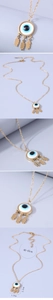 Close-up of golden evil eye pendant necklace with three leaf charms and size details