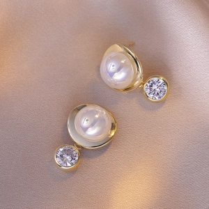 Elegant French style gold pearl earrings with sparkling zircon on silk background