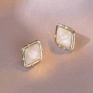 Elegant gold geometric rhombus stud earrings with cream inlay and pearl accents