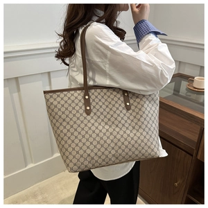 Detail of vintage geometric pattern tote bag on model in a minimalist cafe setting