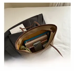 Macro view of beige tote bag interior showing spacious capacity for tablets and daily items