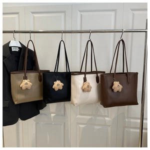 Detailed view of structured tote bags in khaki, black, cream, and brown with star charms