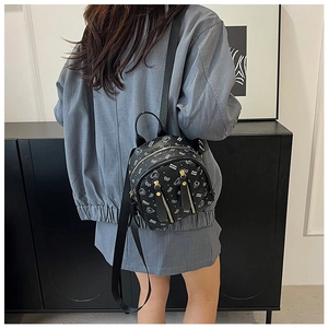 Detail of black mini PU leather backpack with white cartoon bear prints and dual zippers