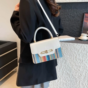 Fashionable white crossbody bag with rainbow knit texture and gold clasp on a model