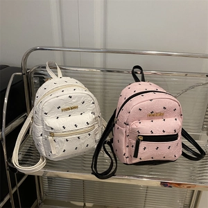 Sweet mini backpacks in white and pink with textured bow patterns and gold labels