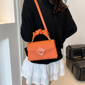 Bright orange small square shoulder bag with V-quilted texture and ruched handle