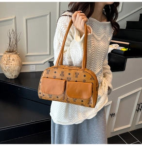 Detailed view of brown teddy bear monogram leather bag with two front flap pockets
