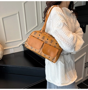 Detail of vintage brown tote bag with bear print and dual front pockets on a model