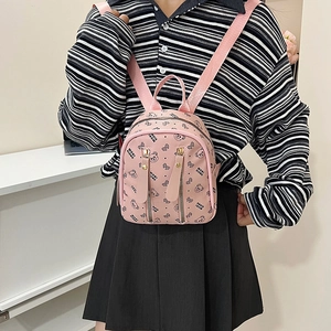 Mini sac à dos rose avec motif ours et détails de fermetures éclair dorées pour femme