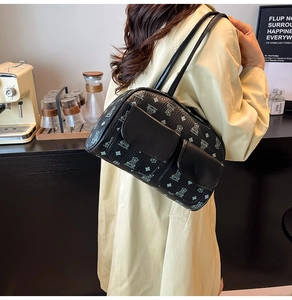 Close-up of black Boston shoulder bag with light blue bear print and double front pockets