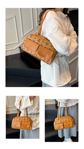 Detail view of vintage brown monogram pillow bag with dual front pockets and top handles