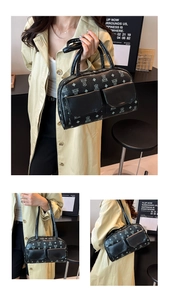 Detail of black Boston bag with bear pattern and double front flap pockets