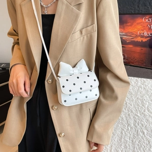 Mini white polka dot crossbody bag with bow accent and white leather shoulder strap