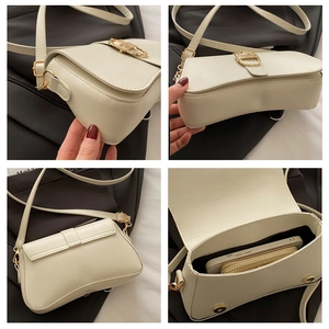 Detail view of cream vintage underarm bag with gold ring hardware and interior storage space