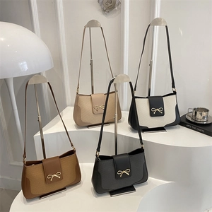 Vintage bow shoulder bags in four colors displayed on a white minimalist pedestal