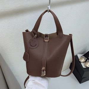 Dark brown lychee leather bucket bag with top handles and gold padlock hardware