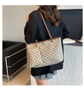 Detail of checkered tote bag with leather strap knot and detachable coin purse