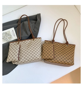 Detail of checkered tote bag set with matching pouch and premium leather straps
