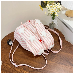 Pink striped backpack with plush stars and rabbit ears on a wooden table setup