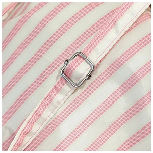 Detailed close-up of pink and white striped fabric with a silver metal adjustment buckle