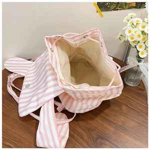 Top view of pink and white striped drawstring backpack with a spacious inner compartment