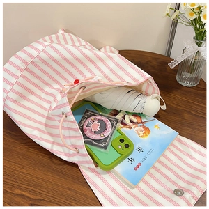 Interior view of pink striped canvas drawstring bucket bag showing large capacity space