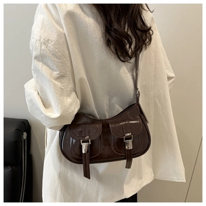 Detailed view of vintage dark brown oil wax leather shoulder bag with buckle pockets